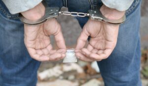 arrested-drug-dealer-in-handcuffs-with-small-heroi-2022-11-14-15-59-05-utc